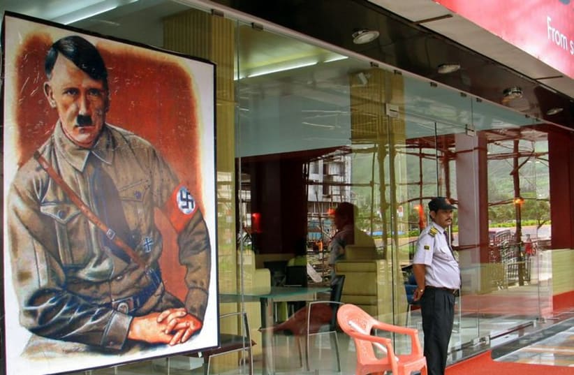 A security personnel stands guard outside a new restaurant, named after Adolf Hitler in Mumbai, India. (photo credit: REUTERS)