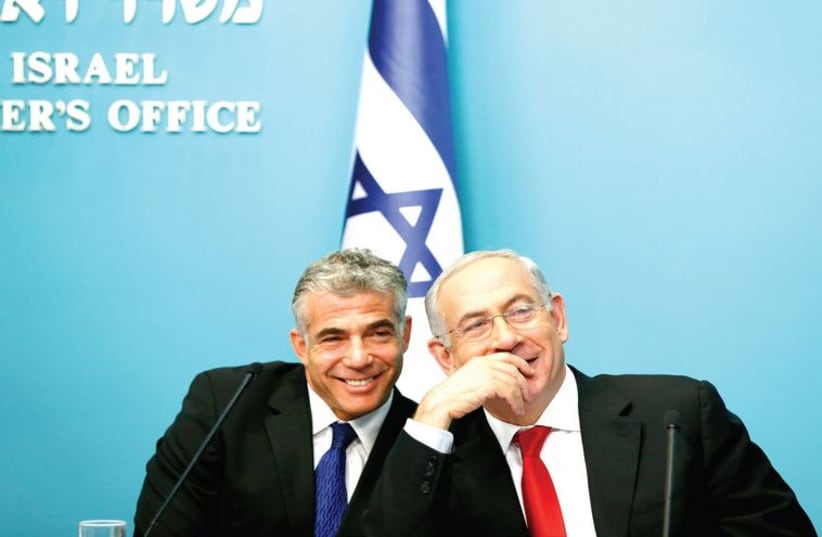 Finance Minister Yair Lapid and Prime Minister Benjamin Netanyahu. (photo credit: RONEN ZVULUN / REUTERS)