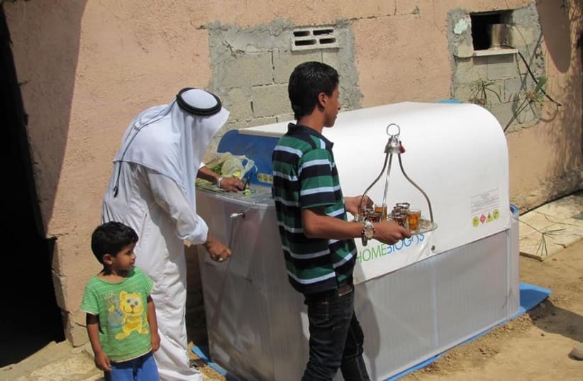 A beduin Umm Batin resident uses the HomeBioGas system. (photo credit: MINISTRY OF ENVIRONMENTAL PROTECTION)