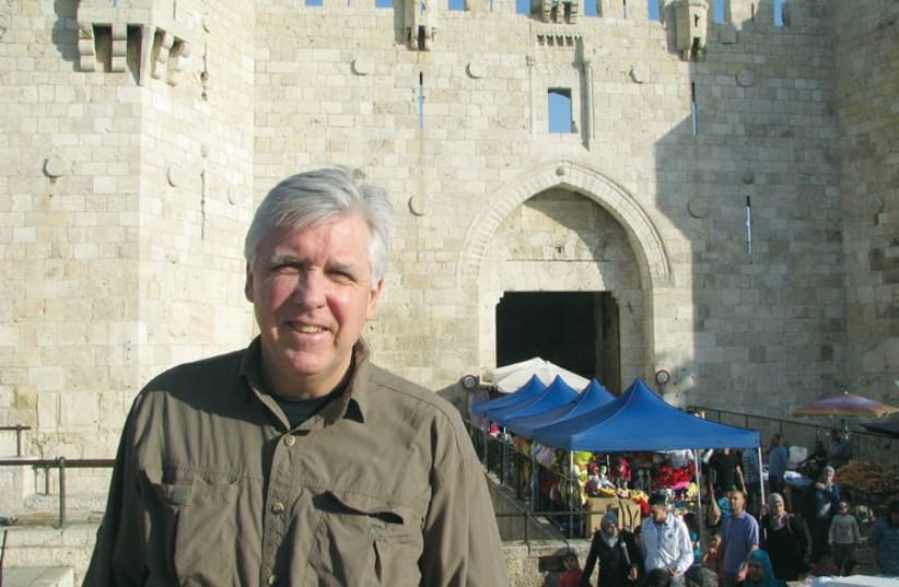 Mike Kelly in front of Damascus Gate while researching his book. (photo credit: Courtesy)