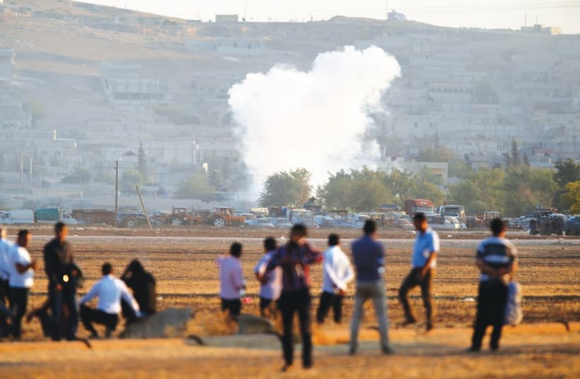 SMOKE RISES from the Syrian town of Kobani (photo credit: REUTERS)