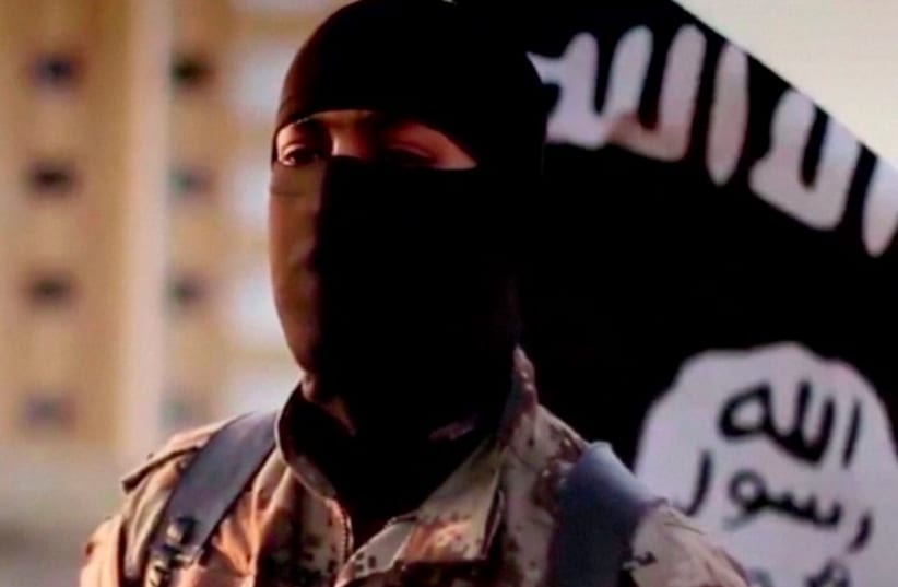 A masked man speaking in what is believed to be a North American accent in a video that Islamic State fighters released in September 2014. (photo credit: REUTERS)