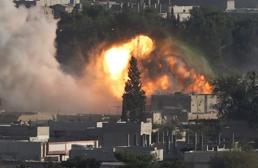 Smoke rises after an U.S.-led air strike in the Syrian town of Kobani October 10, 2014.  (photo credit: REUTERS)