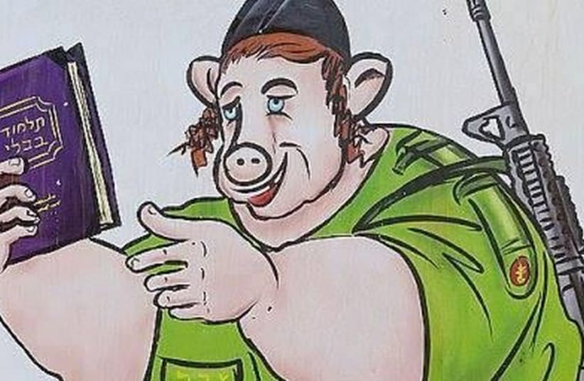 Hamas cartoon of IDF soldier dressed as a pig while holding the Talmud (photo credit: TWITTER)