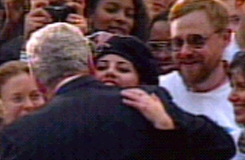 Monica Lewinsky hugs President Clinton in a file photo.  (photo credit: REUTERS)