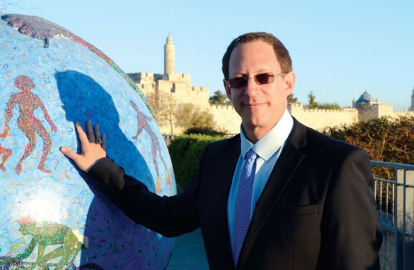 Yosef Abramowitz poses with one of the Green Globes which were scattered around the capital last year. (photo credit: COURTESY ENERGIYA GLOBAL)
