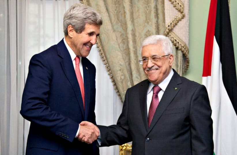 US Secretary of State John Kerry shakes hands with PA President Mahmoud Abbas in Cairo this week. (photo credit: REUTERS)