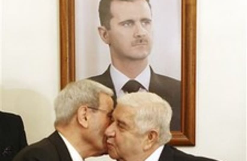 Moallem Salloukh Assad diplo-kiss 224 88 (photo credit: AP)