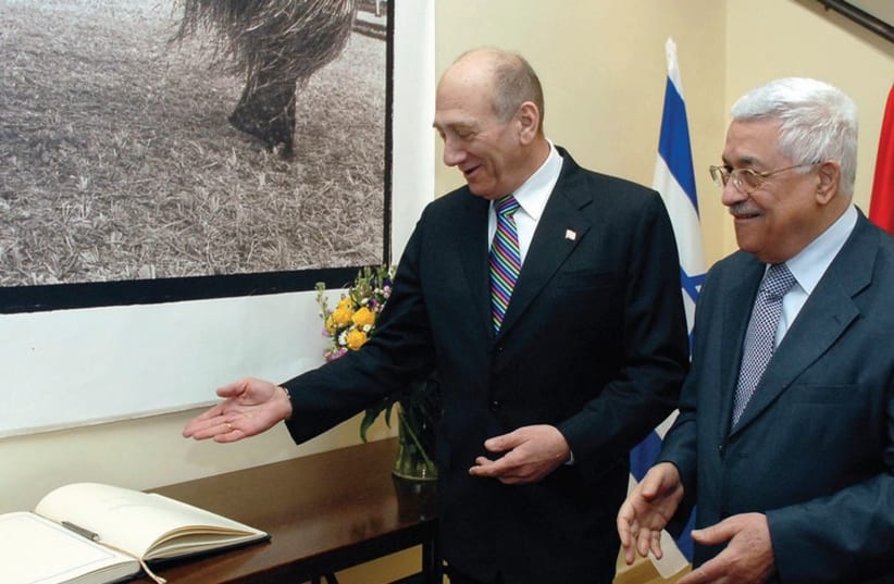 THEN-PRIME Minister Ehud Olmert stands with Palestinian President Mahmoud Abbas during their meeting in Jerusalem in January, 2008 (photo credit: REUTERS)