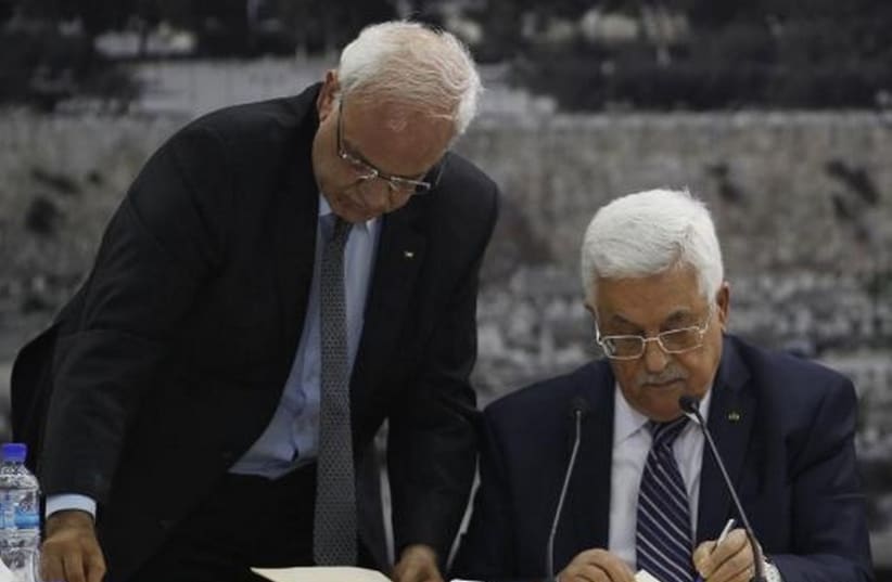 Palestinian Authority President Mahmoud Abbas (R) and his chief peace negotiator, Saeb Erekat, in Ramallah (photo credit: REUTERS)