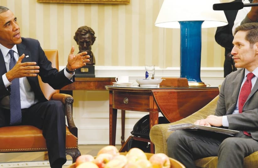 US PRESIDENT Barack Obama speaks with Tom Frieden (photo credit: REUTERS)