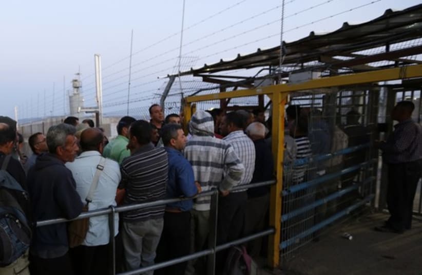 Palestinians wait to cross into Israel at Jalama crossing near Jenin  (photo credit: REUTERS)