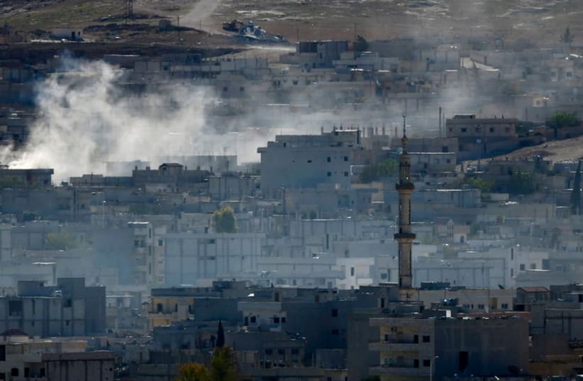 Smoke rises from the Syrian town of Kobani (photo credit: REUTERS)