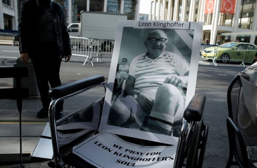 A wheelchair with a photograph of the late Leon Kilnghoffer sits across from the New York Metropolitan Opera, in New York October 20, 2014. (photo credit: REUTERS)