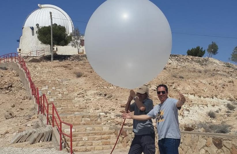 Yoav Yair (right) and a technician launch a balloon two weeks ago in Mitzpe Ramon. (photo credit: COURTESY PROF. YOAV YAIR)