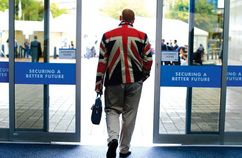 A MAN leaves the Conservative Party convention last month in the UK. (photo credit: REUTERS)