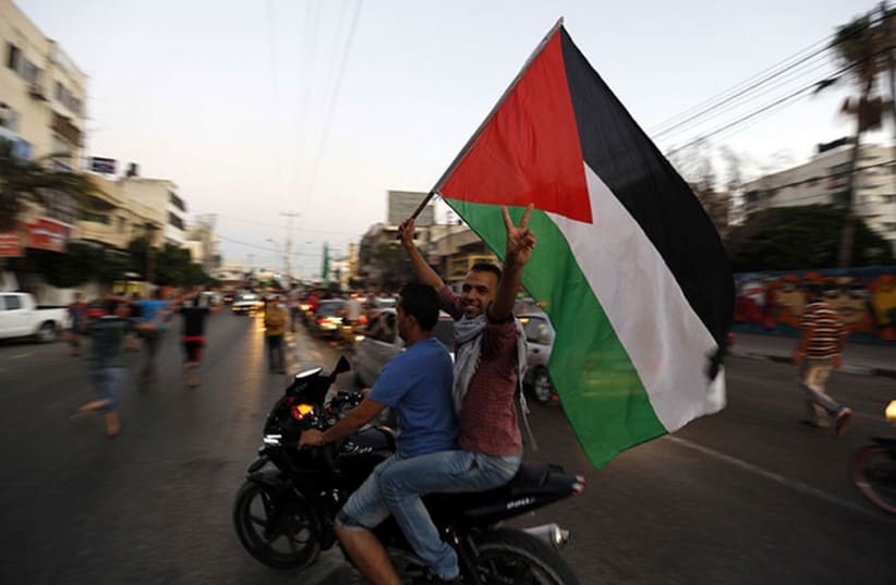 Palestinians in Gaza celebrate cease-fire (photo credit: REUTERS)