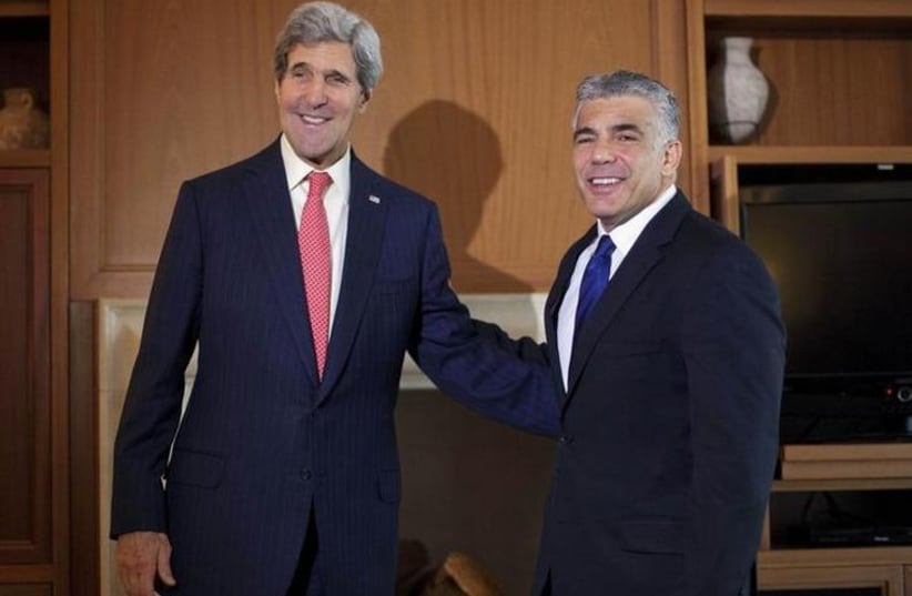 Finance Minister Yair Lapid (R) meets with US Secretary of State John Kerry in Jerusalem (photo credit: REUTERS)