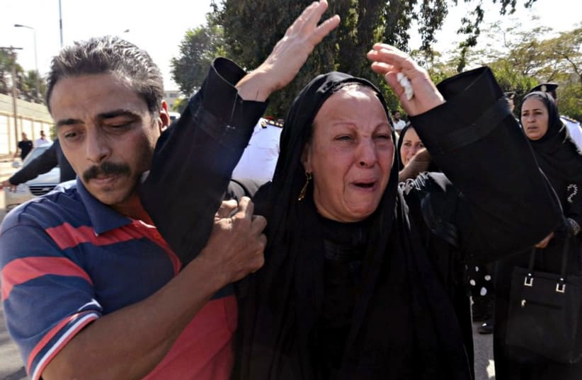 Egyptian woman mourns at funeral of Sinai terror attack victim (photo credit: REUTERS)