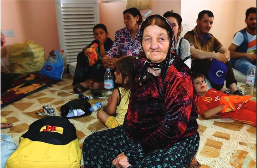 Three generations of a Christian family that fled from the violence in Mosul (photo credit: REUTERS)