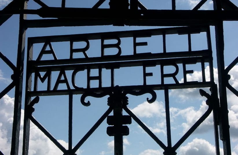 'Arbeit Macht Frei' sign at Dachau (photo credit: Wikimedia Commons)