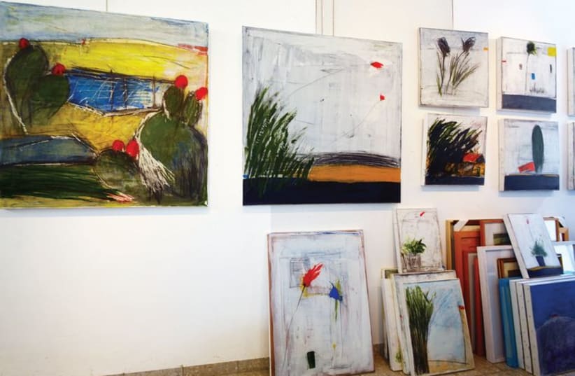 Salah Elkara's paintings displayed in a gallery (photo credit: ITSIK MAROM)