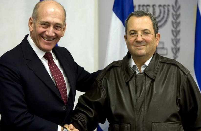 Former prime minister Ehud Olmert (L) shakes hands with his defense minister, Ehud Barak (photo credit: REUTERS)