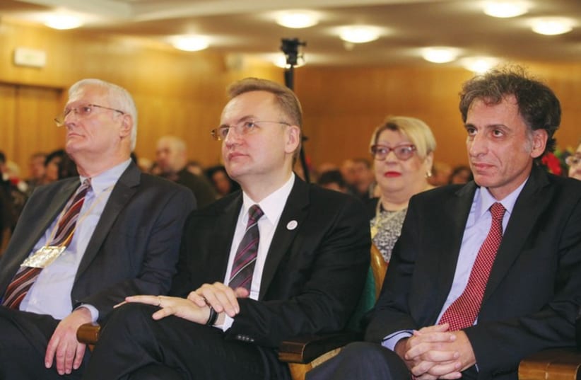 LIMMUD FSU founder Chaim Chesler (left) sits with Lviv Mayor Andriy Sadovyi (center) and Ukraine Ambassador Eliav Belotserkovsky at the organization’s conference in Lviv, Ukraine (photo credit: YOSSI ALONI)