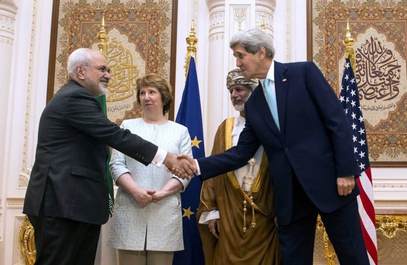US. Secretary of State Kerry and Iranian FM Zarif shake hands as Omani FM Alawi and EU envoy Ashton watch in Muscat. (photo credit: REUTERS)