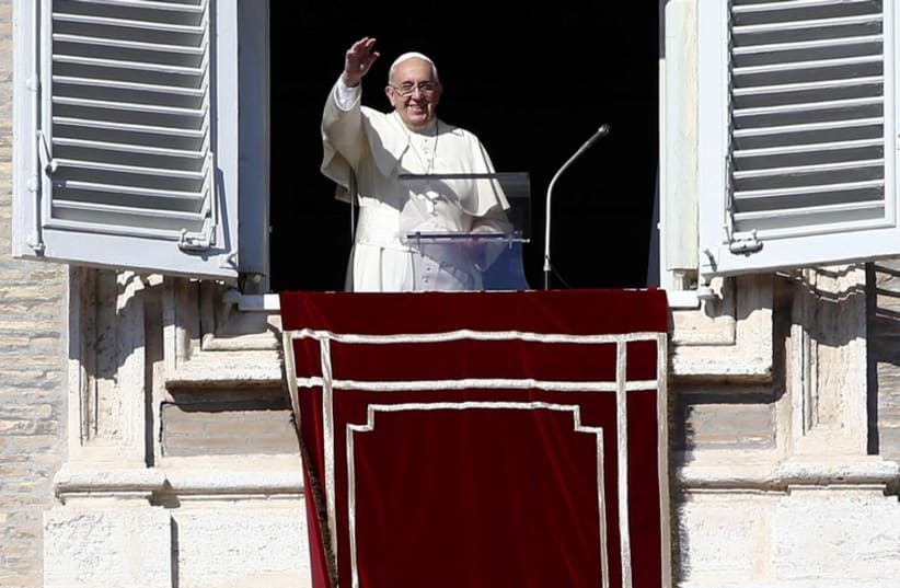 Pope Francis waves during his Sunday Angelus prayer in Saint Peter's Square at the Vatican (photo credit: REUTERS)