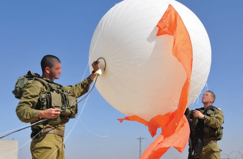 IDF SOLDIERS display a portable surveillance balloon meant to improve the visual intelligence capabilities of field units. (photo credit: IDF SPOKESMAN’S UNIT)