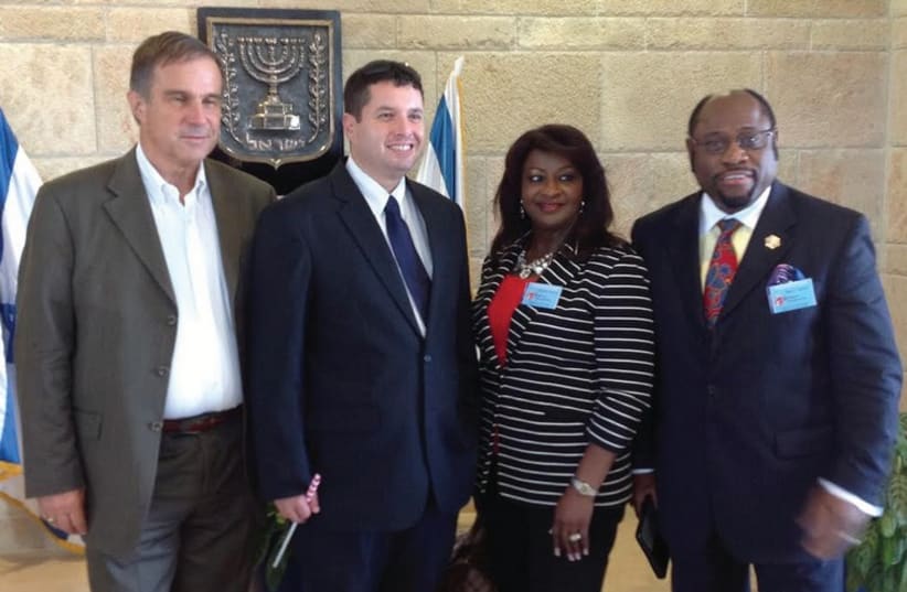 Pastor Myles Munroe (right) and his wife at the Knesset six weeks ago with Josh Reinstein (second left), the director of the Knesset Christian Allies Caucus, and Pastor Tom Hess (photo credit: KNESSET CHRISTIAN ALLIES CAUCUS)