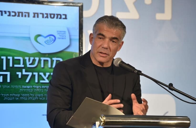 Yair Lapid speaking at a conference titled "Treatment of Holocaust survivors in Israel - Present and Future Challenges" (photo credit: MOTI ZEEVI)
