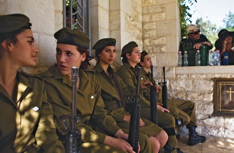 Soldiers attend a Remembrance Day ceremony at the British Commonwealth cemetery in Ramle last Sunday. (photo credit: REUTERS)