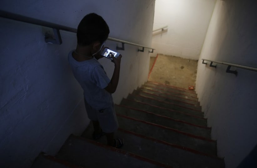 Cell phone in rocket shelter (photo credit: REUTERS)