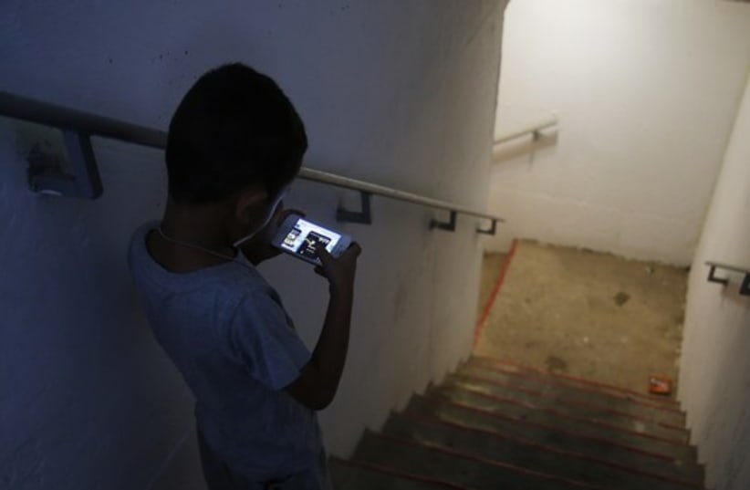 Cell phone in rocket shelter (photo credit: REUTERS)