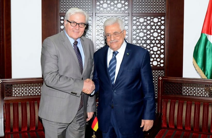 PA President Mahmoud Abbas (R) shakes hands with Germany's Foreign Minister Frank-Walter Steinmeier in Ramallah,  November 15, 2014 (photo credit: REUTERS/OSAMA FALAH/PALESTINIAN PRESIDENT OFFICE ()