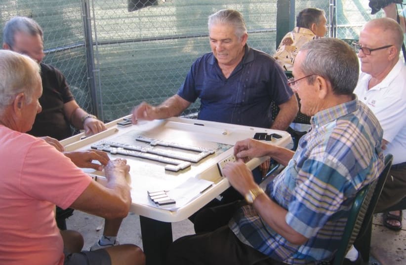 RESIDENTS OF Little Havana pass the time playing dominoes. (photo credit: BEN G. FRANK)