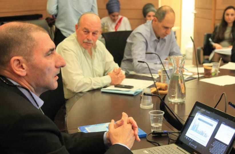 Finance Ministry chief economist Yoel Naveh (left) speaks to the Knesset Finance Committee in Jerusalem (photo credit: KNESSET)
