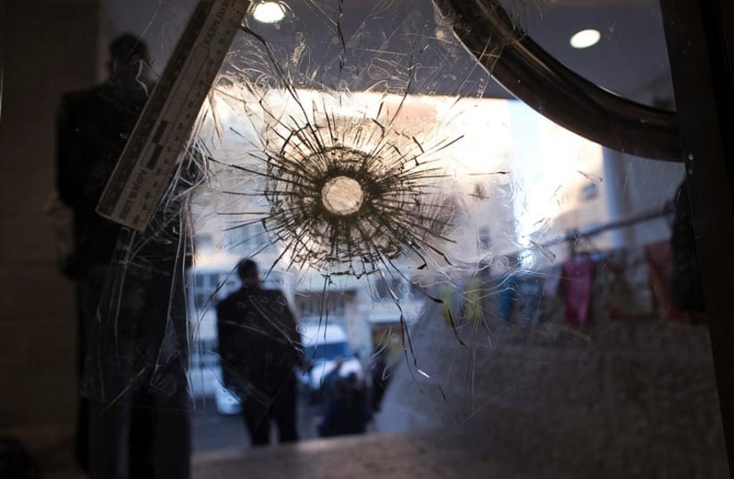 A bullet hole in a door of the Jerusalem synagogue where two Palestinian terrorists killed four rabbis and a police officer, November 19, 2014 (photo credit: REUTERS)