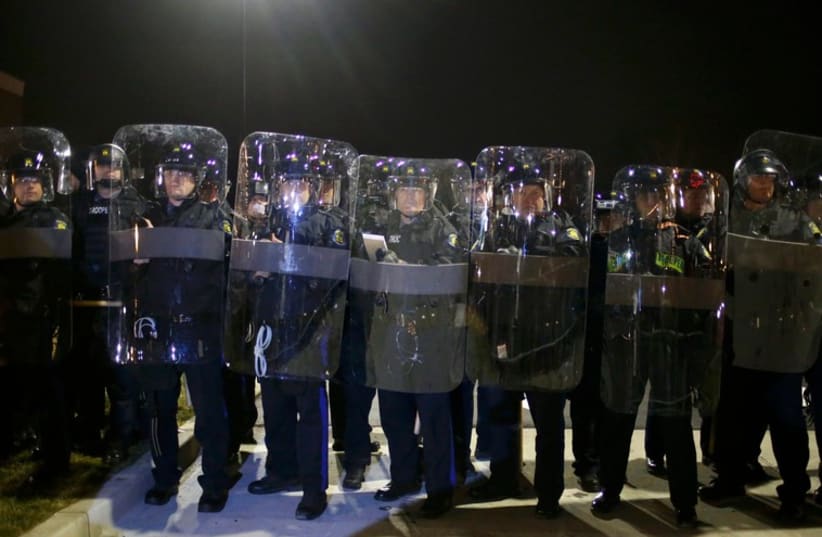 Missouri State Troopers in riot gear stand in formation outside the Ferguson Police Department in Ferguson, Missouri, November 24, 2014. (photo credit: REUTERS)