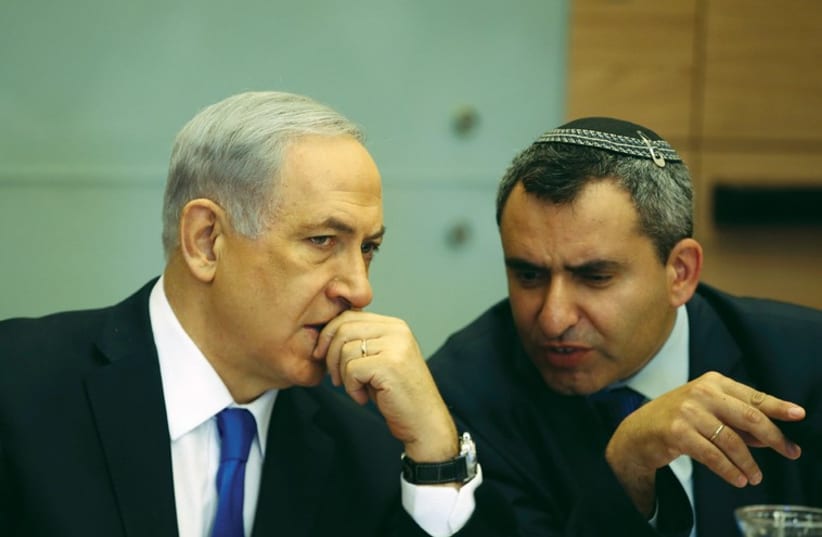 Prime Minister Benjamin Netanyahu listens to Zeev Elkin during a committee meeting at the Knesset in Jerusalem in June. (photo credit: REUTERS)
