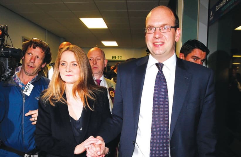 United Kingdom Independence Party (UKIP) candidate Mark Reckless, the former Conservative Party member of Parliament for Rochester and Strood, and his wife Catriona Brown, arrive for the by-election ballot count at Medway Park in Gillingham, southeast England in November. (photo credit: REUTERS)