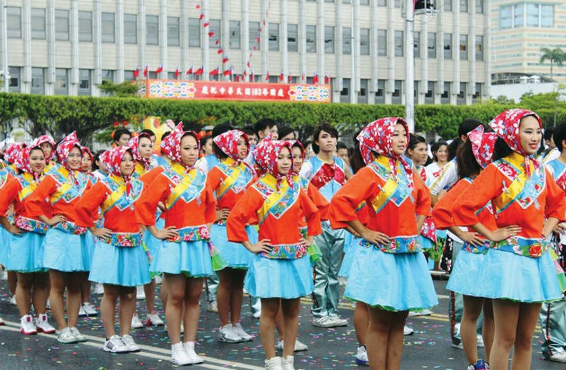 Women wear traditional Taiwanese costumes for its National Day parade in Taipei city center. (photo credit: BEN HARTMAN)