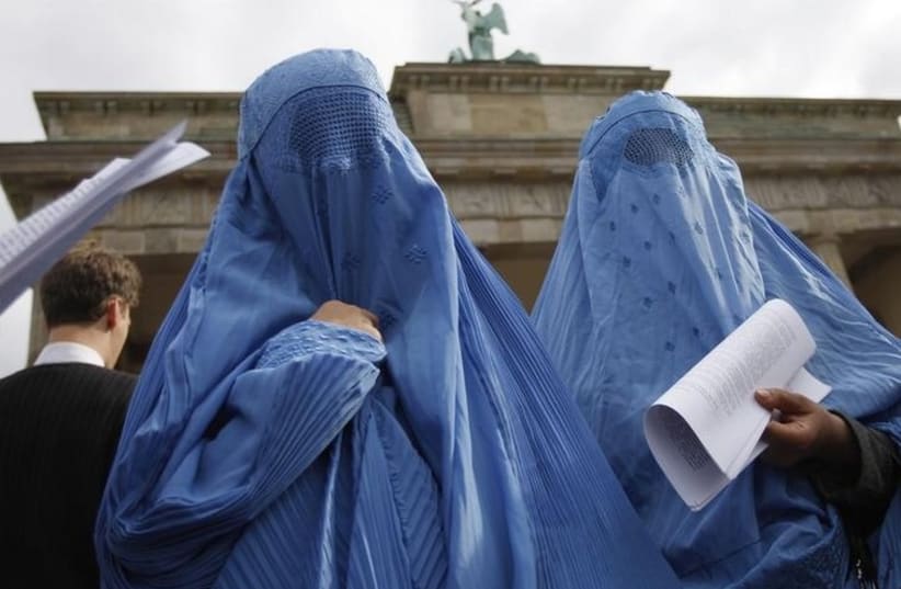  Women dressed in traditional burqa garments in Berlin (photo credit: REUTERS)