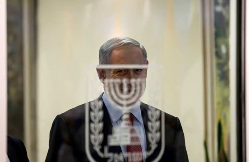 Prime Minister Benjamin Netanyahu smiles before delivering joint statements to the media in Jerusalem December 1 (photo credit: REUTERS)