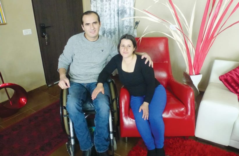 Aamer Tafish and his wife Botaina in their home. (photo credit: TAMARA ZIEVE)