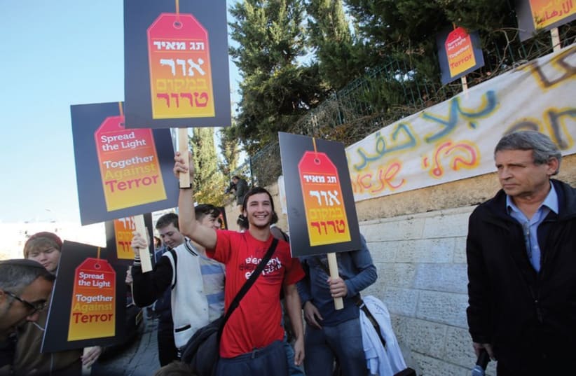 Tag Meir activists carrying signs of support (photo credit: COURTESY TAG MEIR)
