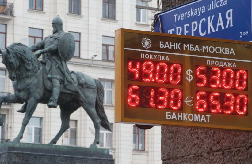 A BOARD showing currency exchange rates in Moscow on Monday, when oil prices fell to their lowest in five years. Russia’s ruble dropped more than 4 percent against the dollar while Malaysia’s ringgit, also oil-dependent, was on course for its biggest two-day fall since the 1997-8 Asian financial cri (photo credit: REUTERS)