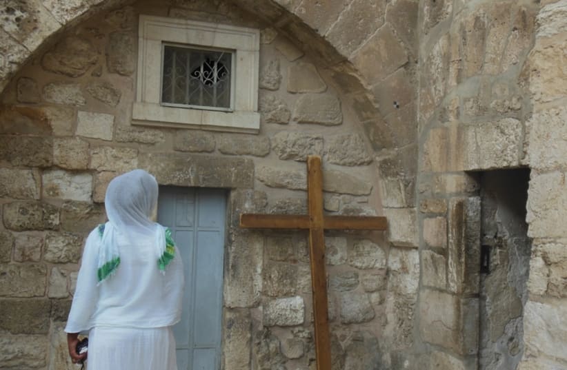 A Christian woman outside the Church of the Holy Sepulchre in Jerusalem (photo credit: ARIEL COHEN)